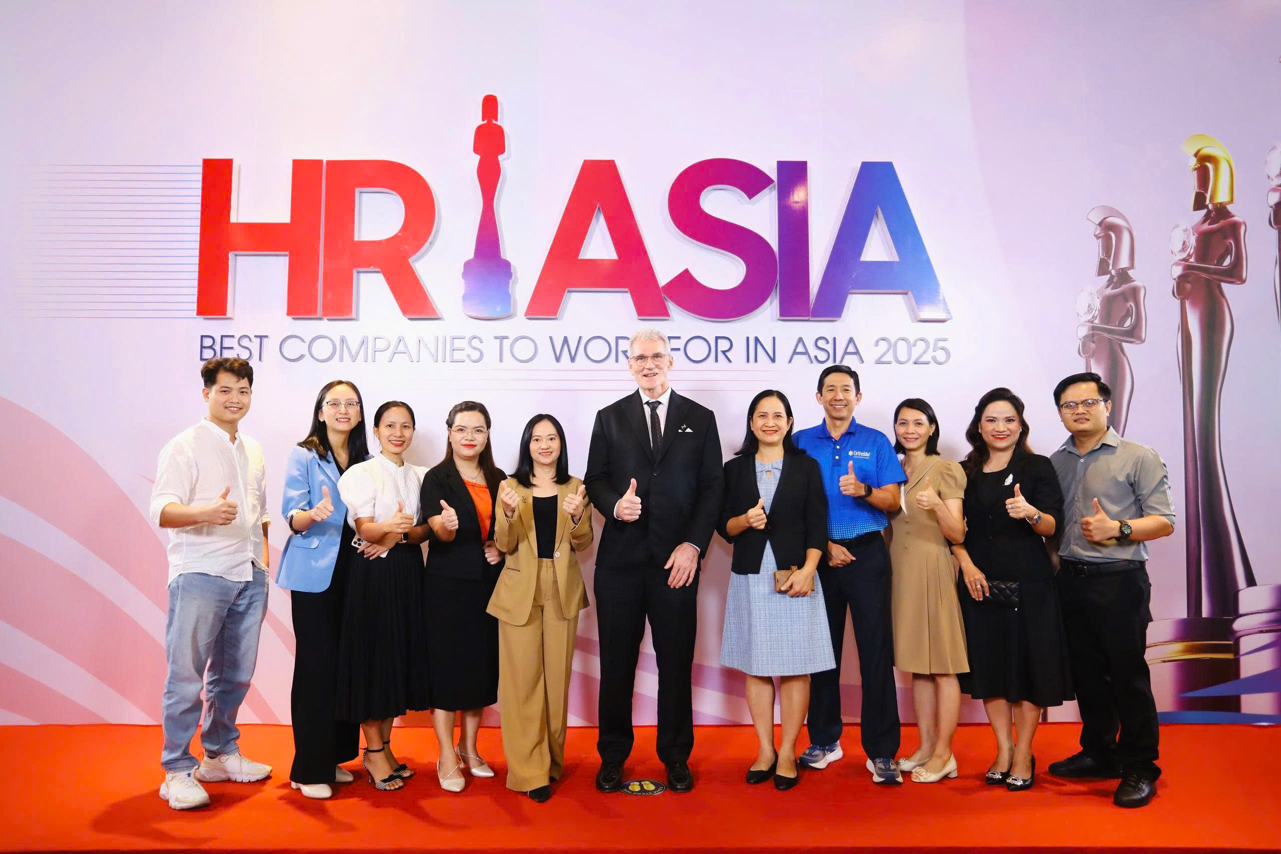 Mark Coffield, Country Manager for OrthoLite Vietnam accepts award alongside OVN team